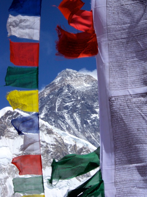 A view of Everest's summit through prayer flags