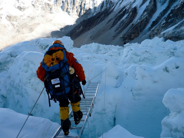 TA crossing a ladder in the Khumbu Icefall