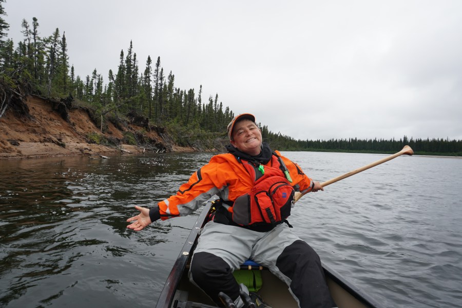 TA smiling with arms wide open on the Adlatok River in Labrador
