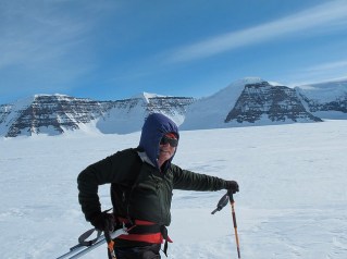 TA in front of mountains in Greenland.